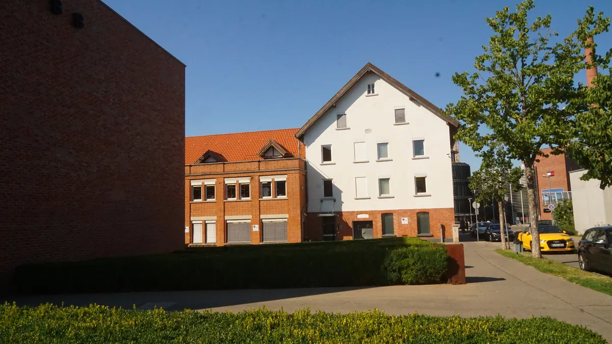 Brick and white office buildings on the Hugo Boss AG site in Metzingen, Germany